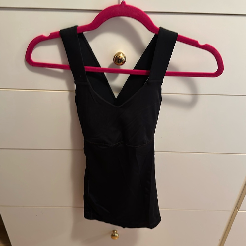 Lululemon black workout top. Straps cross in the back. Built in bra. Size 2